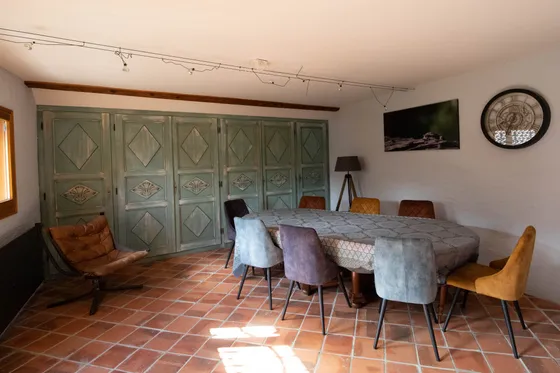 The table laid for ten, in front of the old green-painted cupboards